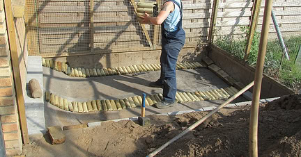 Rabbit enclosure construction with wooden and wire fencing.
